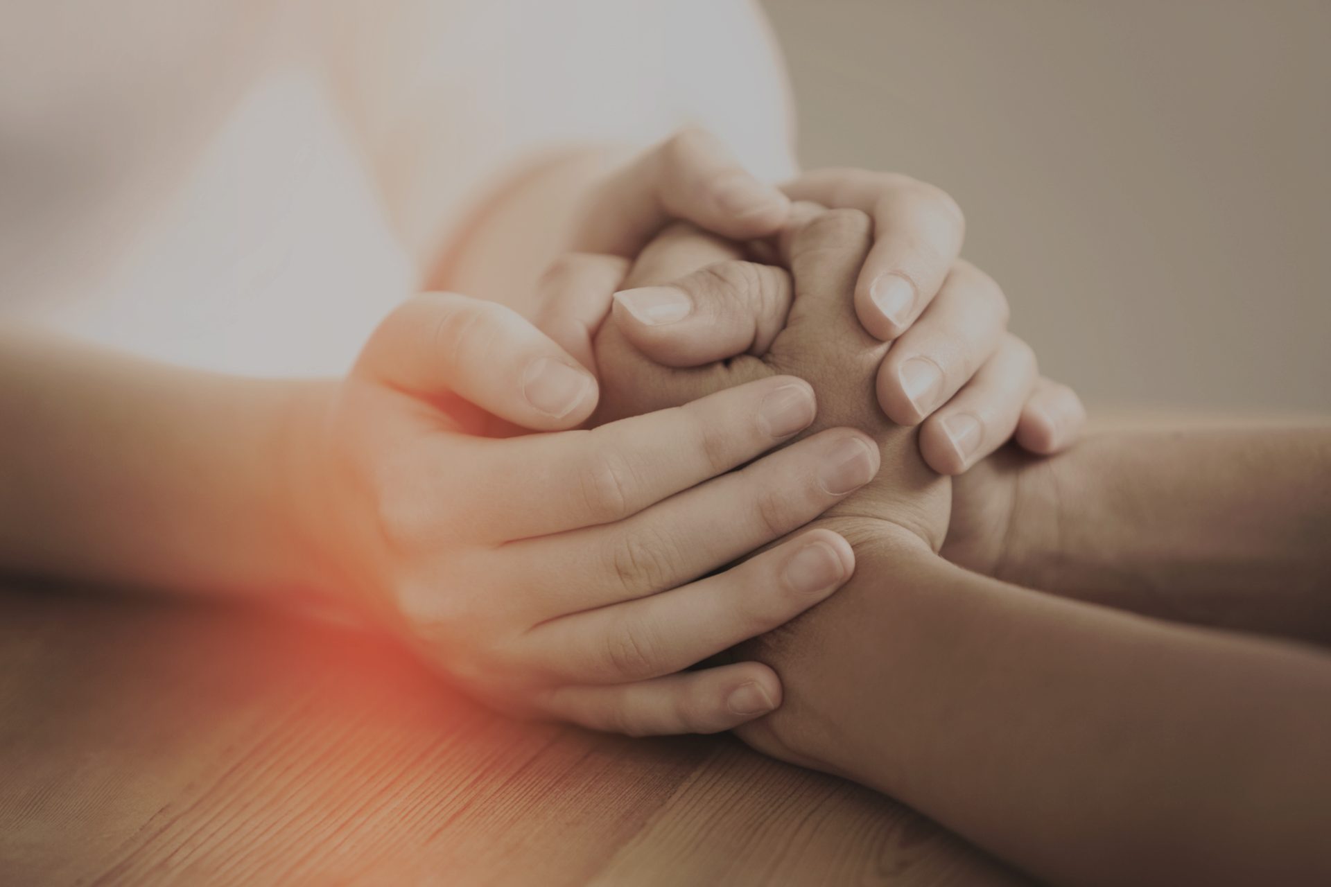 Two people holding hands in a moment of support
